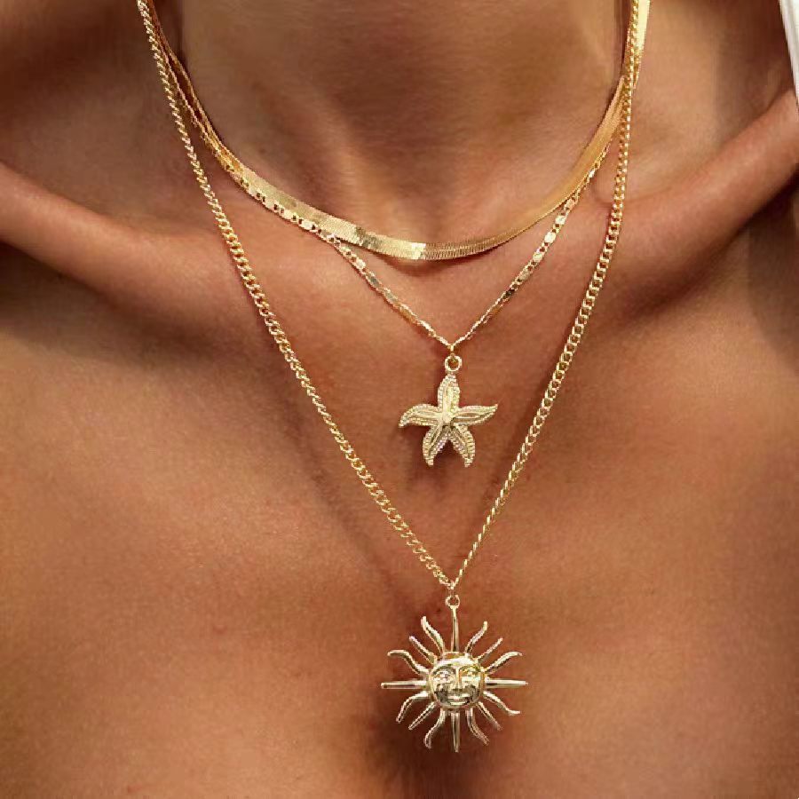Layered gold-plated necklace set with starfish and sun pendant
